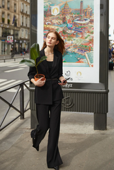 a lady wears a black blazer with matching suitpants